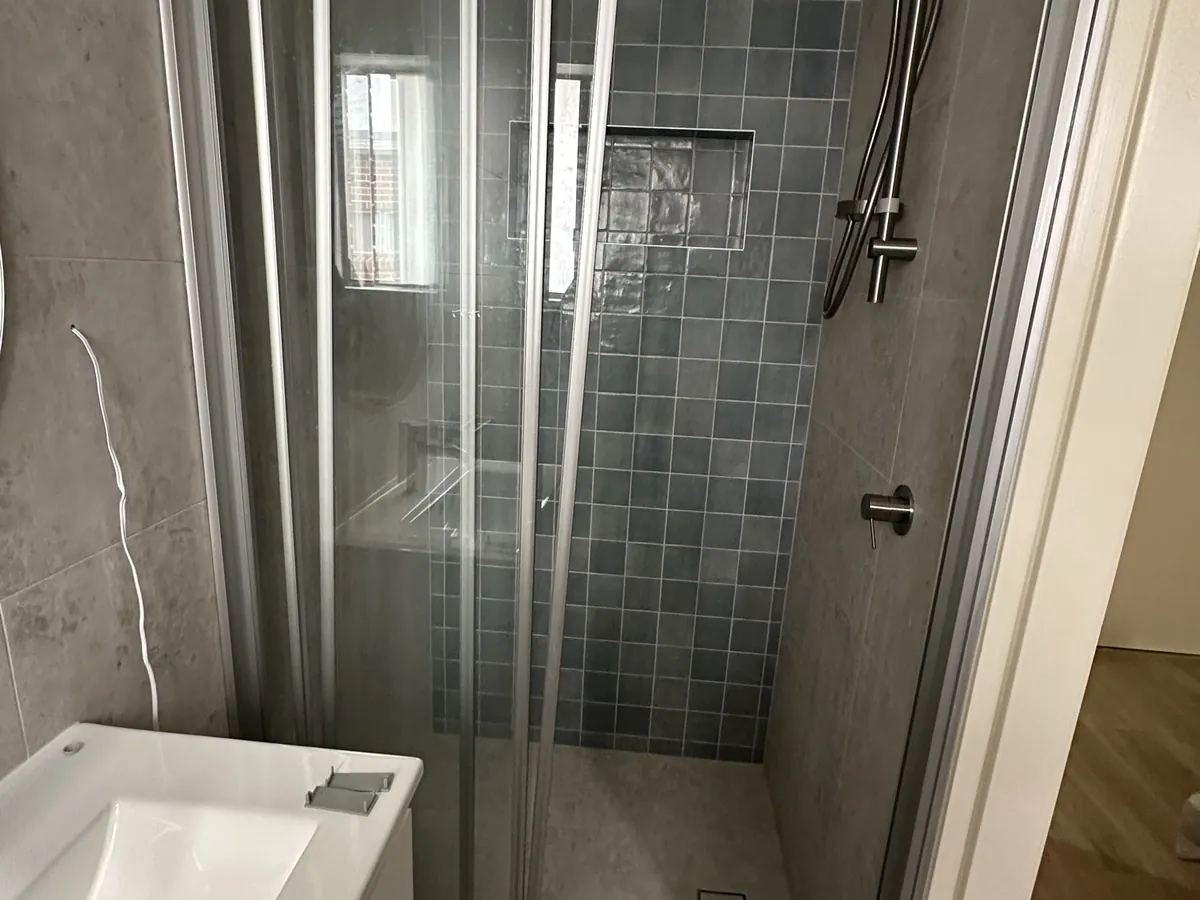 New sliding shower screen, rail shower and wall-hung vanity fitted off in a Padstow bathroom