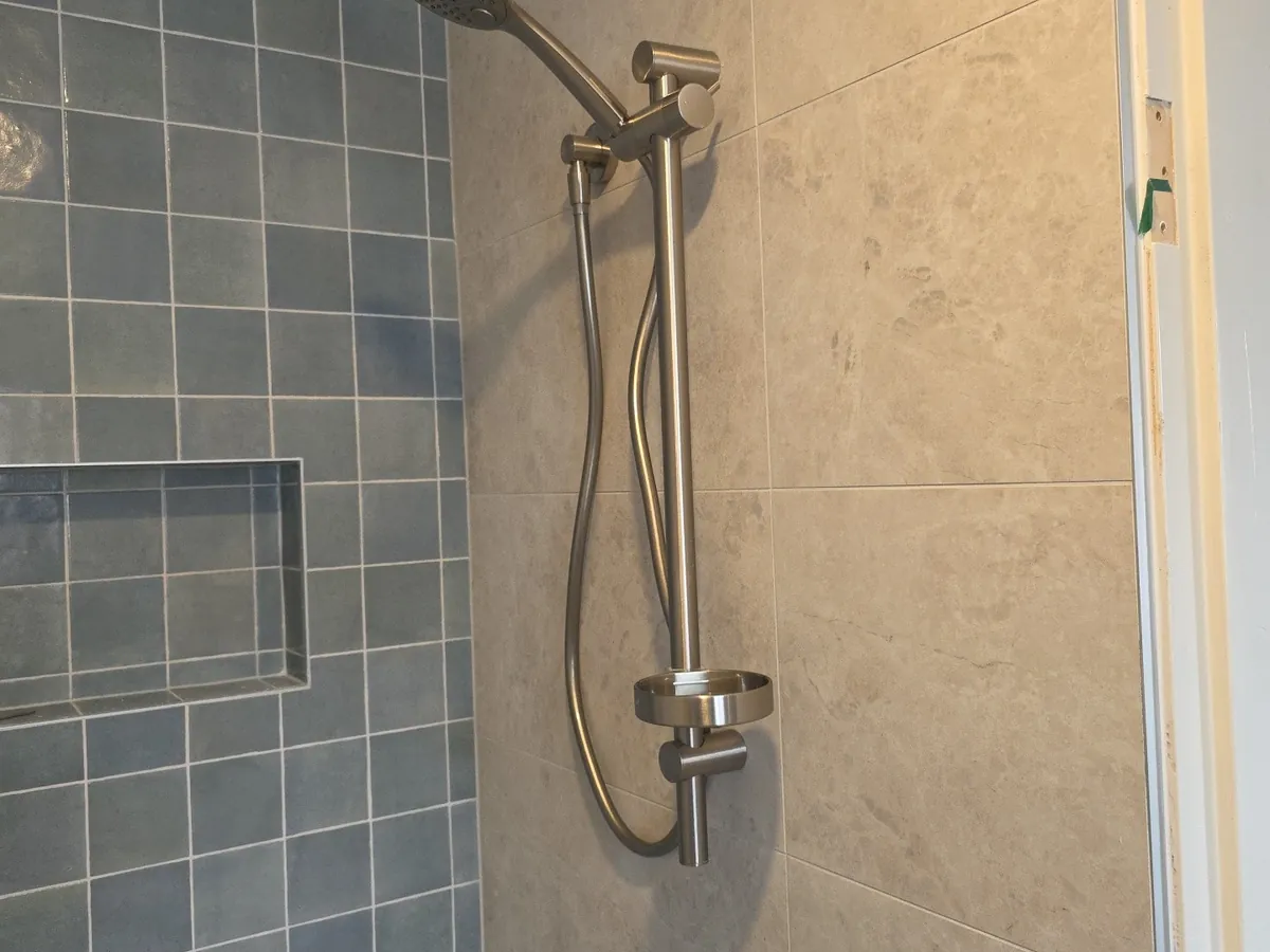 Retiled shower with blue tiles, a recessed niche and new rail shower in Padstow