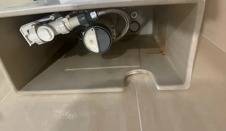 Inlet valve and flush valve inside a toilet cistern with the lid off in Newington