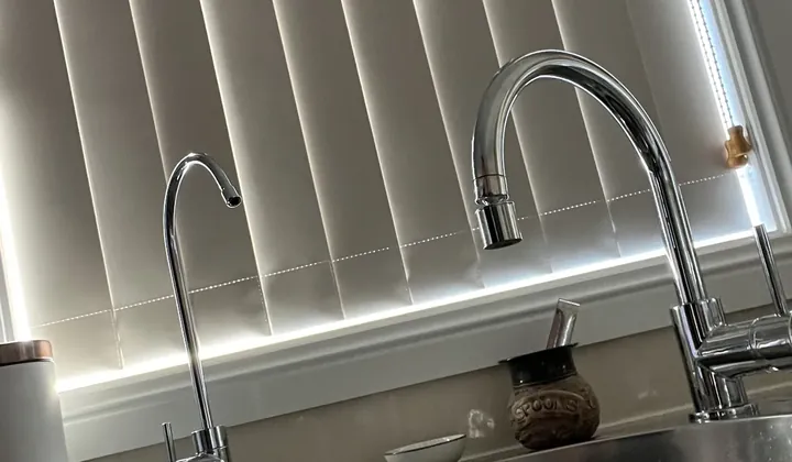 Chrome filter tap beside the kitchen mixer on a stainless steel sink in Whalan