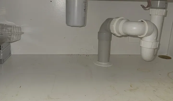 New water filter housing on a bracket beside the sink wastes under a kitchen sink in Edmondson Park