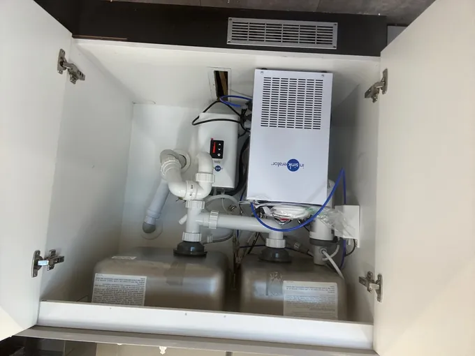 Under-sink boiling and chilled water units filling a kitchen cupboard in North Ryde