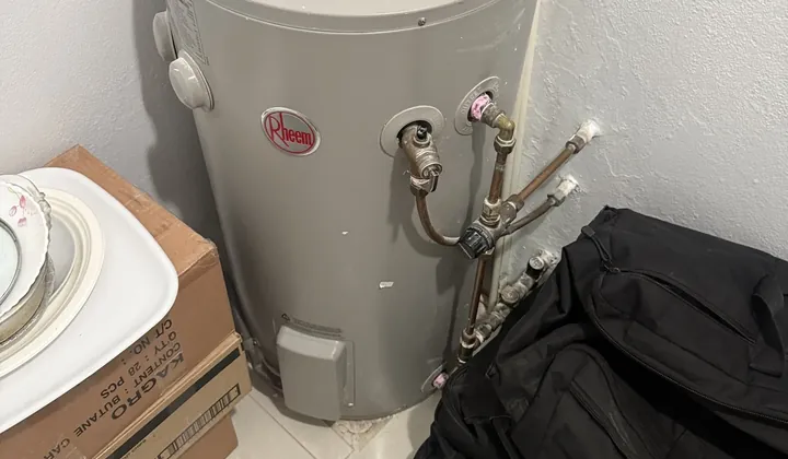Rheem electric hot water tank with its relief valve and hot water outlet pipes in Bankstown