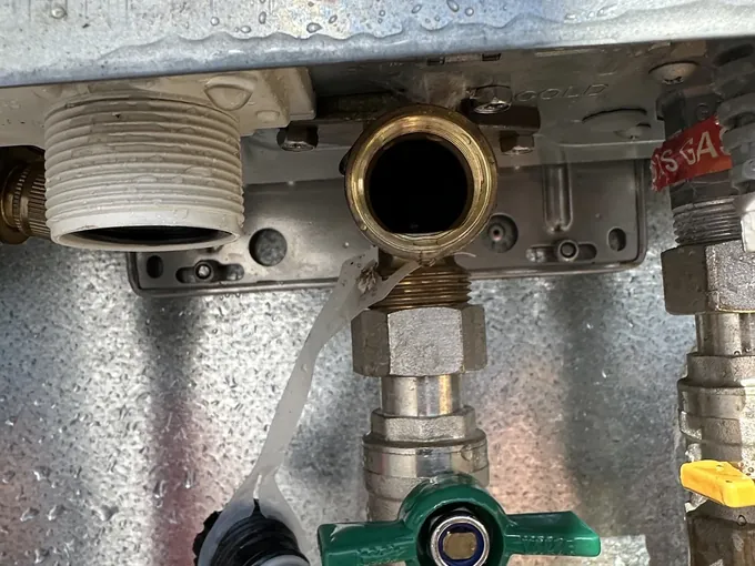 Water inlet filter taken out beside the green cold water valve under a gas hot water unit in Spring Farm
