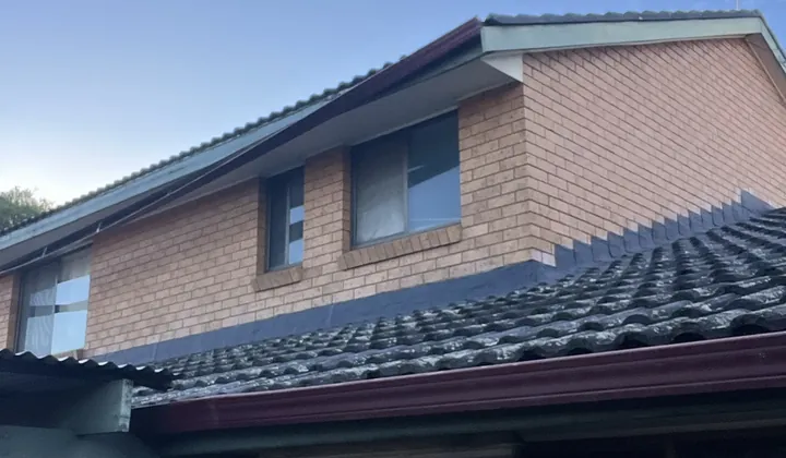 Upper and lower gutters along a tiled roof on a two-storey brick home in Wakeley