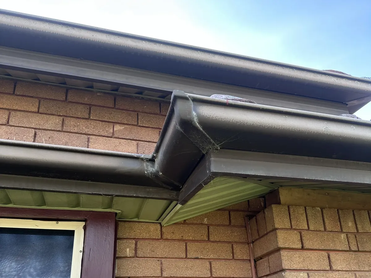 Gutter corner and downpipe on the eaves of a brick home in Westmead