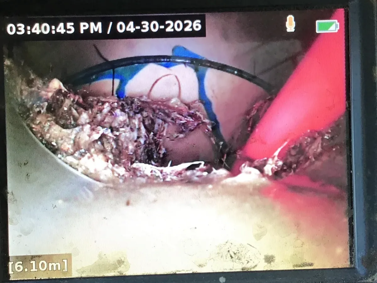 Debris caught at a pipe joint beside the jetter hose, seen on the drain camera 6 metres down the line, in Baulkham Hills
