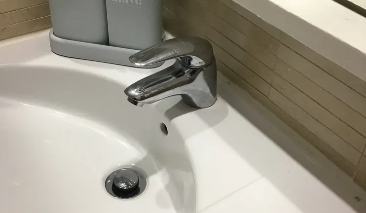 Chrome single-lever basin mixer on a white bathroom basin