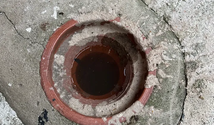 Overflow relief gully with the grate off, ringed with sewage residue, in Greystanes