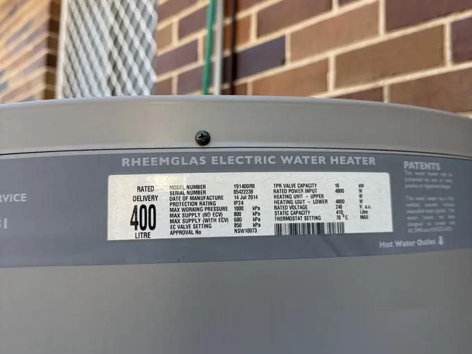 Data plate on a Rheemglas electric water heater showing 400 litre rated delivery