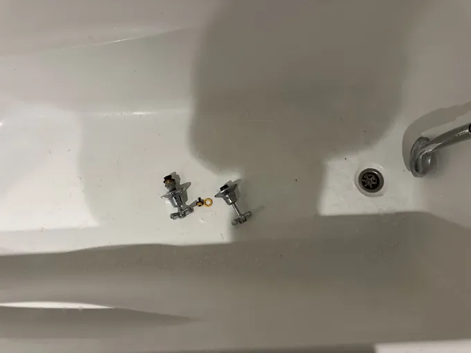 Bath with the worn tap spindles taken out in Surry Hills
