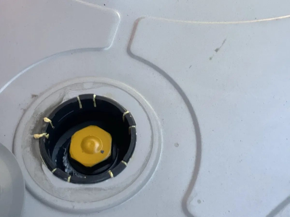 Cover off the top of a hot water tank with the fitting underneath exposed in Blacktown