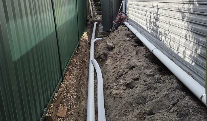 Two new storm water pipes laid in a trench along the side of a house in Jannali