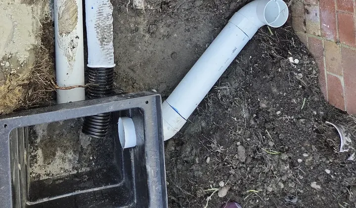 New stormwater pit with storm water pipes and a downpipe bend connected into it in Jannali
