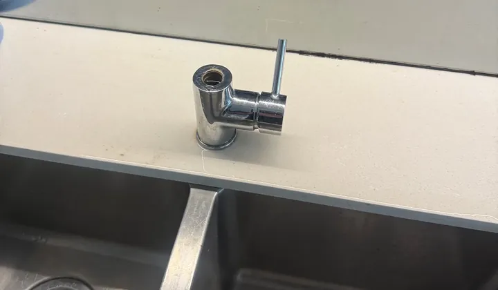 Chrome kitchen mixer on a stone benchtop above a double sink in Mascot