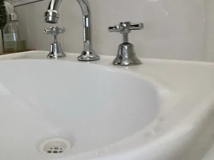 Chrome basin taps and spout on a white bathroom basin in Prestons