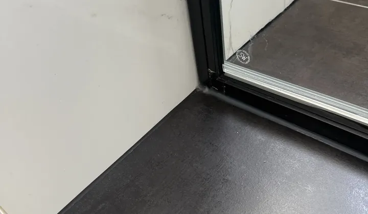 Close-coupled toilet suite fitted in a tiled bathroom