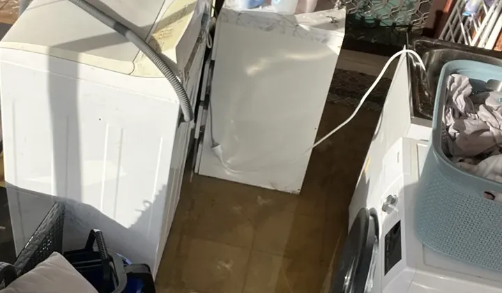 Top loader and front loader washing machines pulled out beside a floor waste in Green Valley