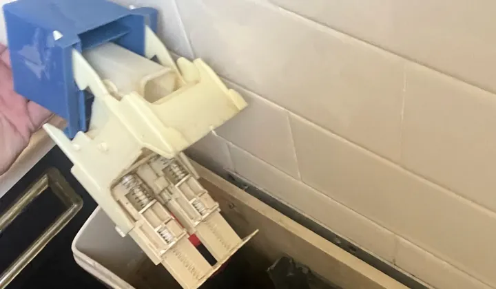 Flush valve lifted out of a toilet cistern that kept running, for repair in Campsie