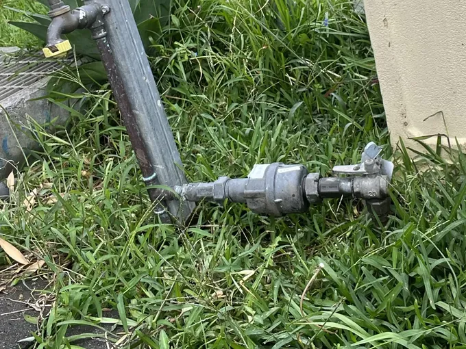 Water meter and meter tap on a galvanised riser in the front lawn in Punchbowl