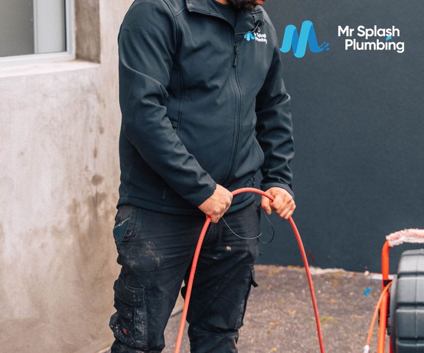 Mr Splash plumber clearing a blocked drain with a high pressure jetter