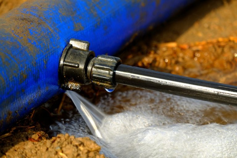 Water escaping from a damaged underground water pipe